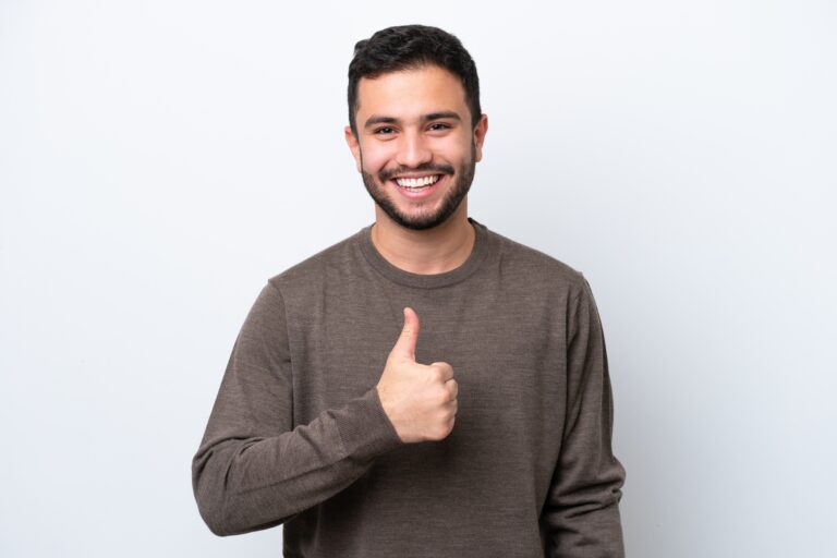 Young,brazilian,man,isolated,on,white,background,giving,a,thumbs 